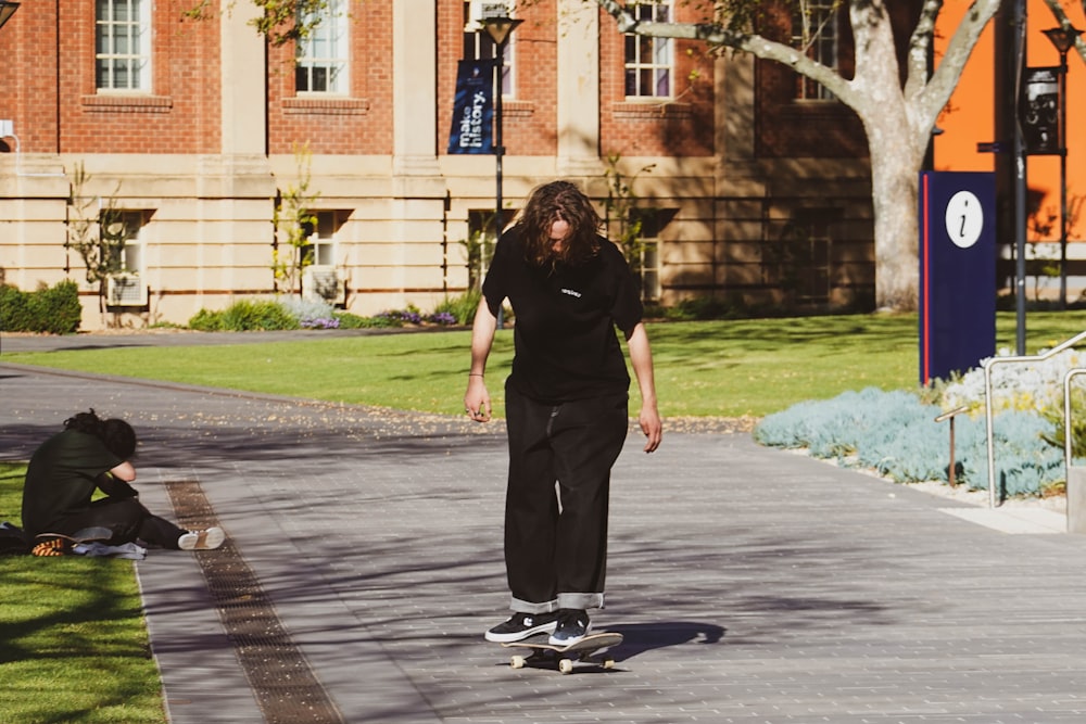 a man riding a skateboard down a sidewalk