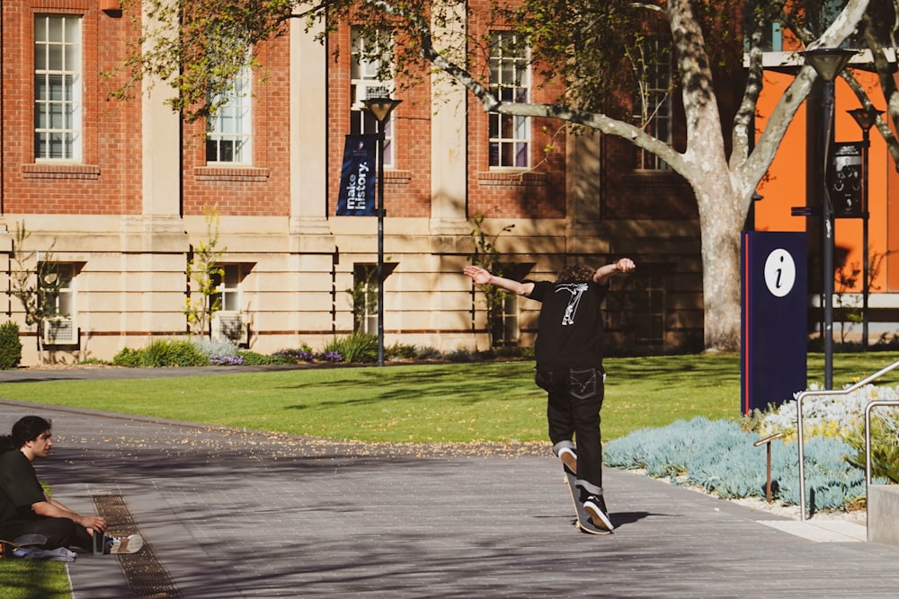 a man riding a skateboard on top of a sidewalk