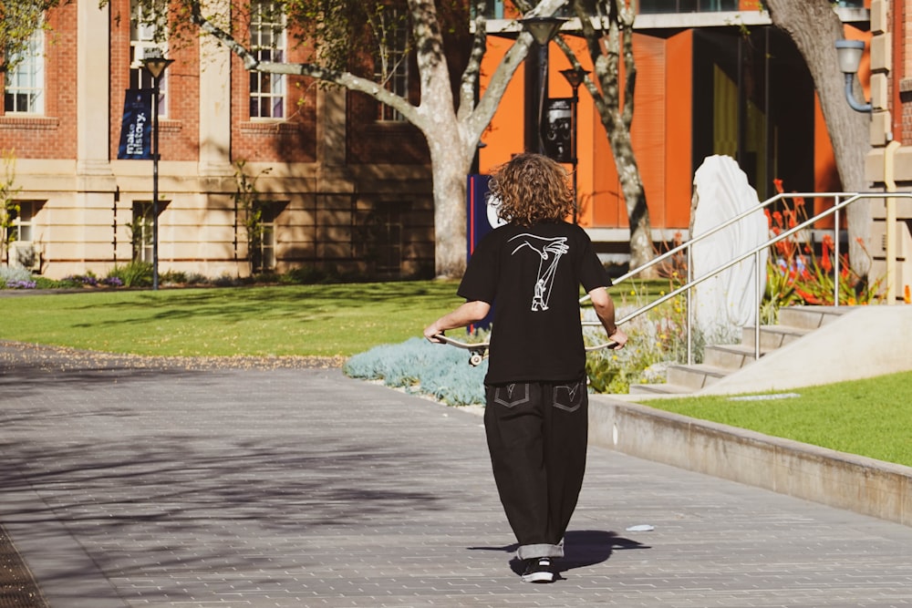 a man riding a skateboard down a sidewalk