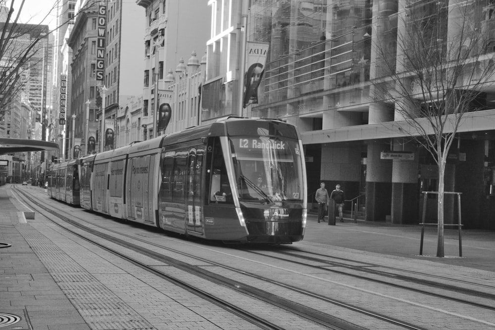 a black and white photo of a train on the tracks