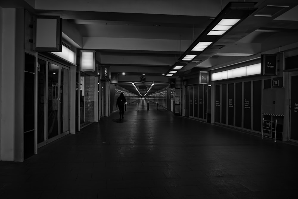 a person walking down a long hallway in a building