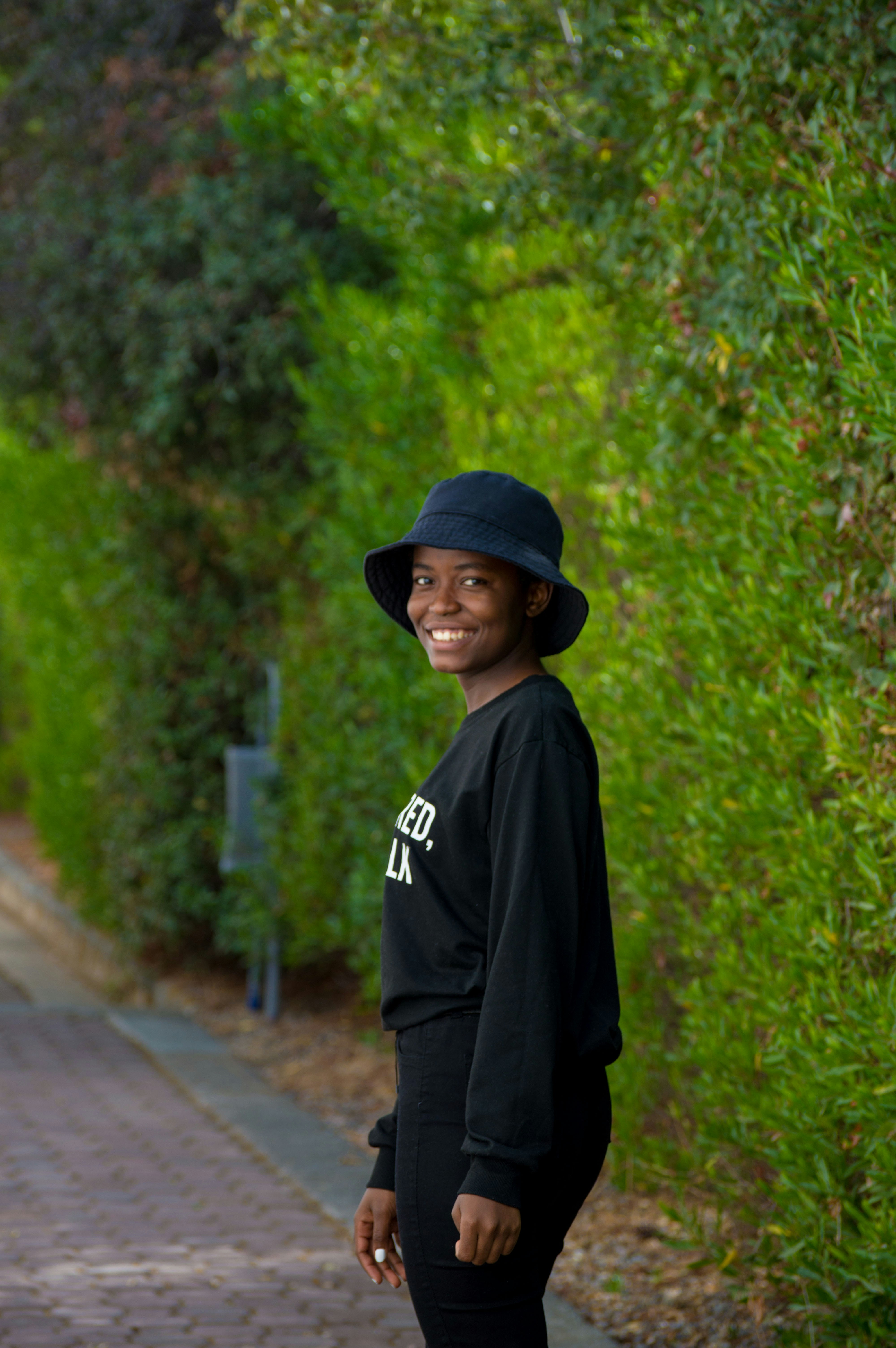 a woman wearing a black hat and a black sweatshirt