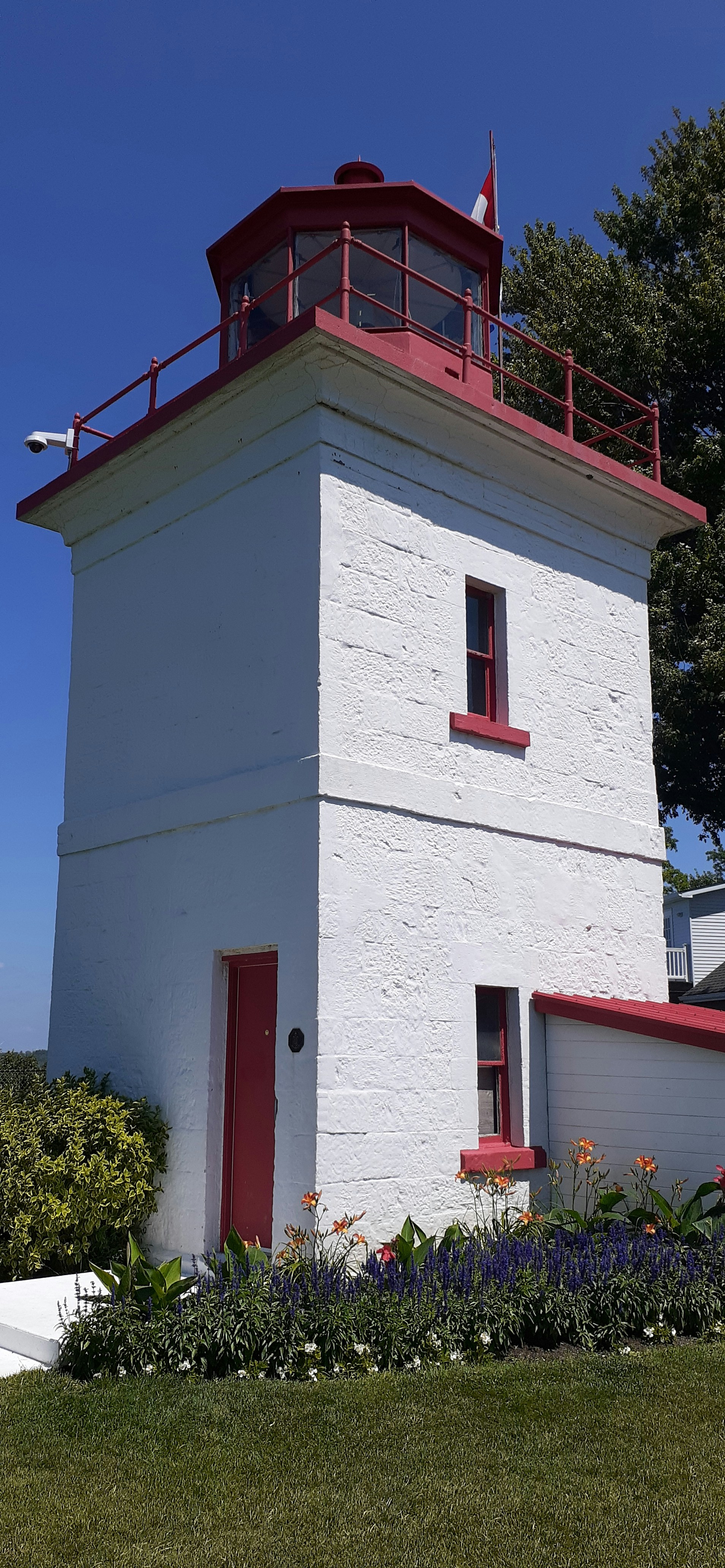 a white building with a red roof and a red door