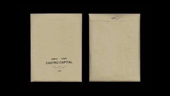 Two beige envelopes are displayed against a black background. The envelope on the left has printed text reading 'Desarrollo I, Rie, Auto Marketing, Castro Capital' with a decorative symbol below. The envelope on the right is flipped to show the plain back with a metal clasp.