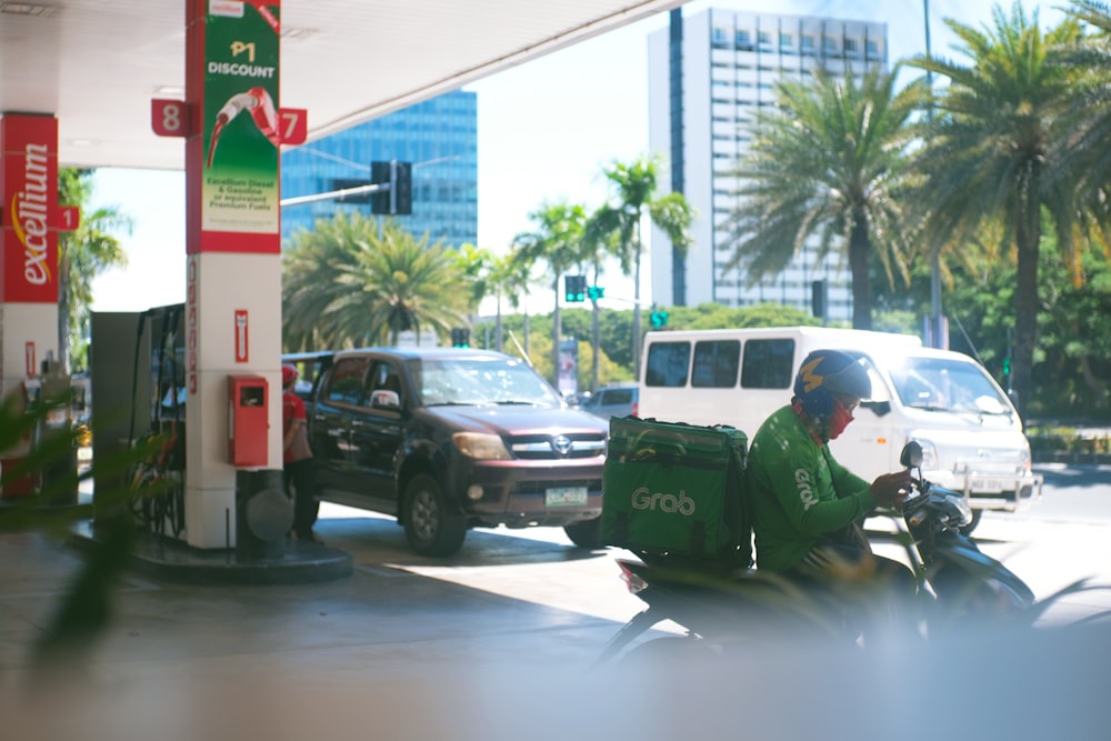 a man on a motorcycle at a gas station