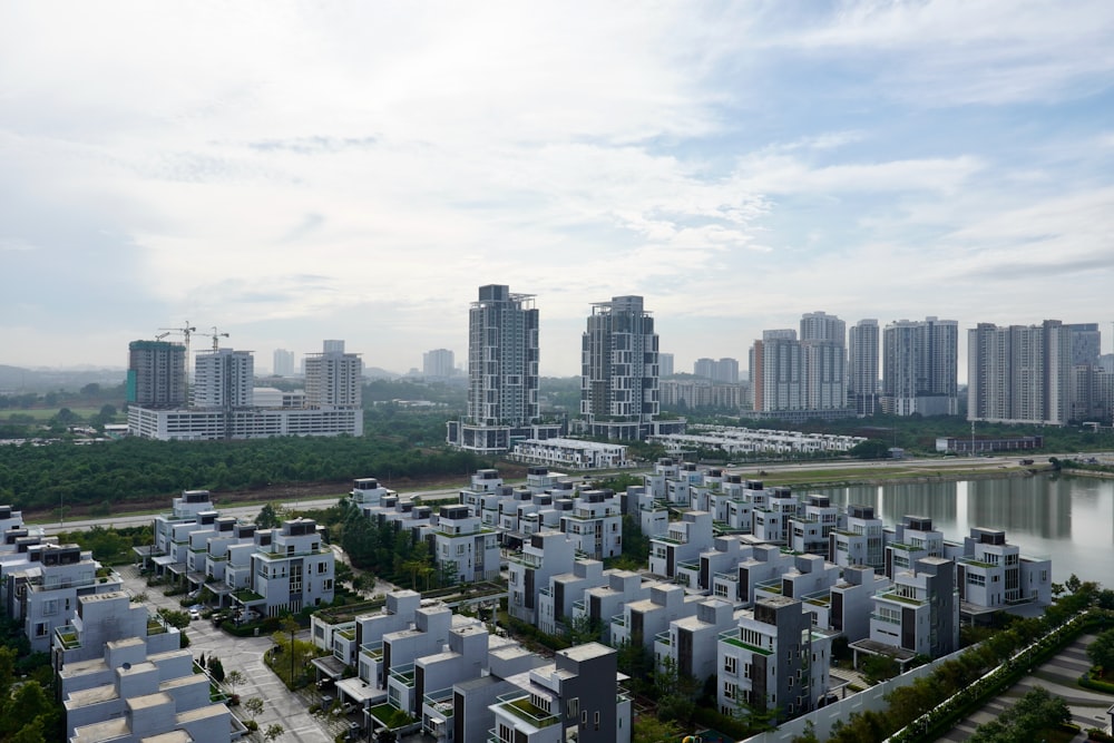 a city with lots of tall buildings next to a lake