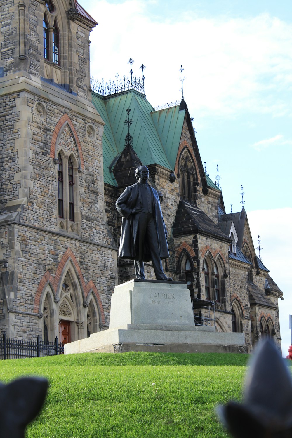 a statue of a man in front of a church