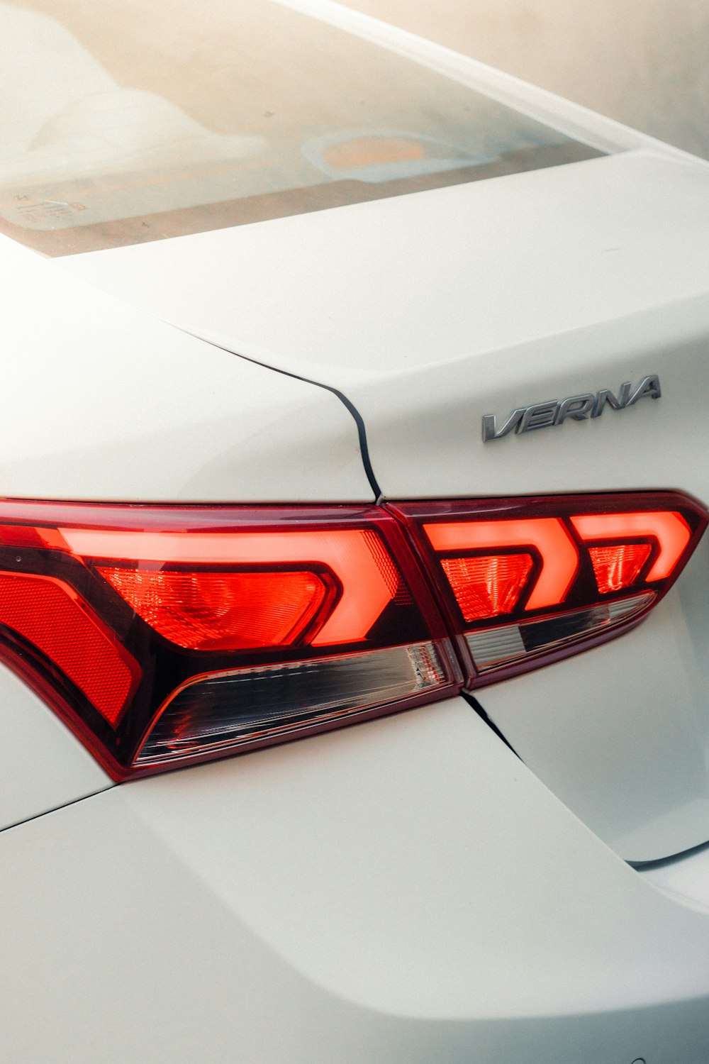 a close up of the tail lights of a white car