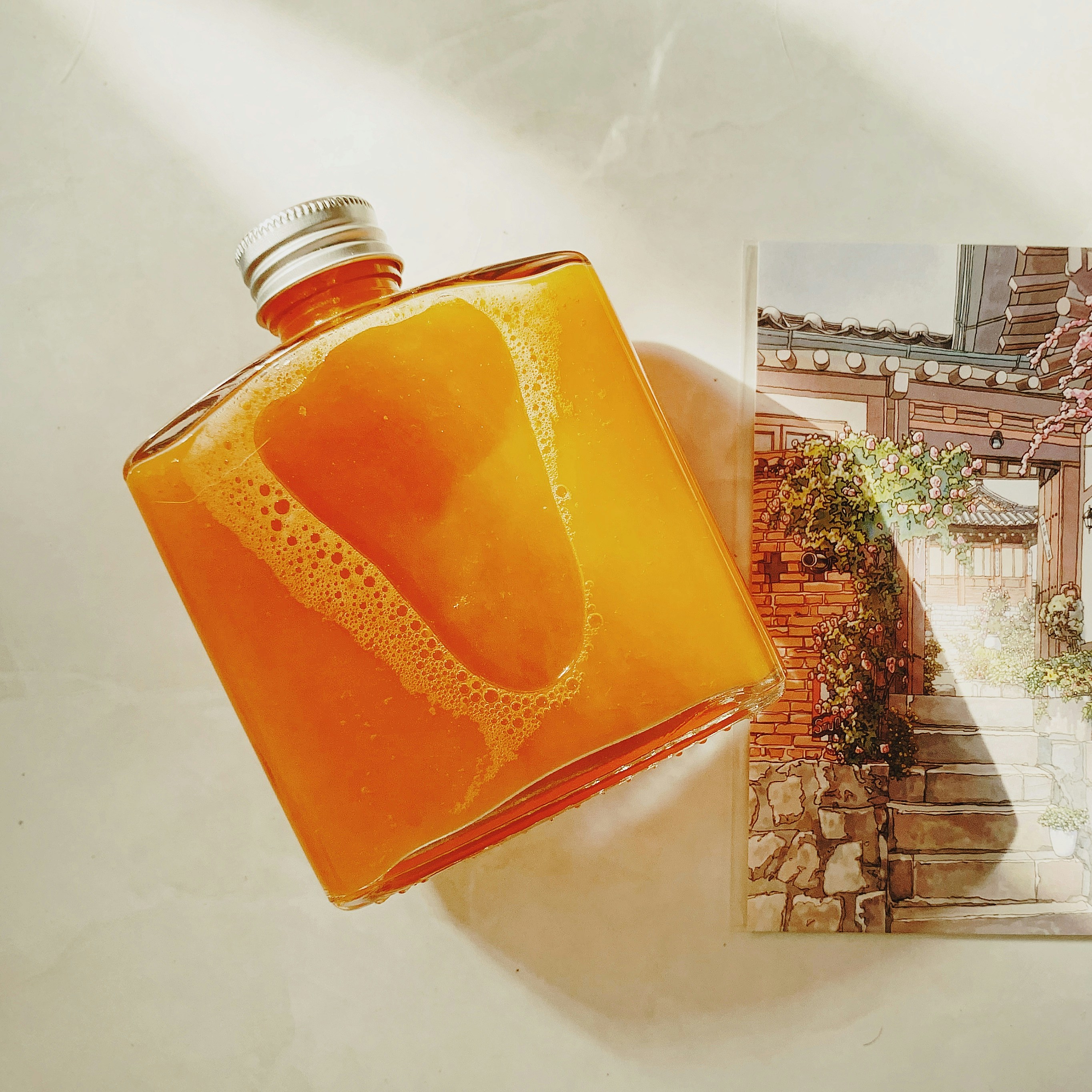a bottle of liquid sitting on top of a table