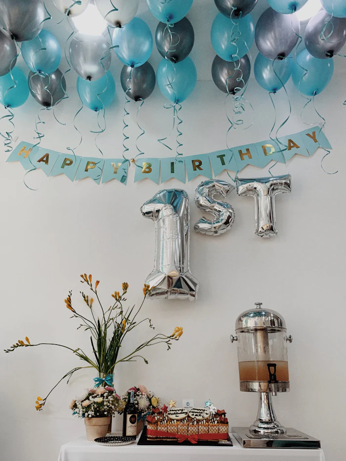 Table with balloons and birthday cake
