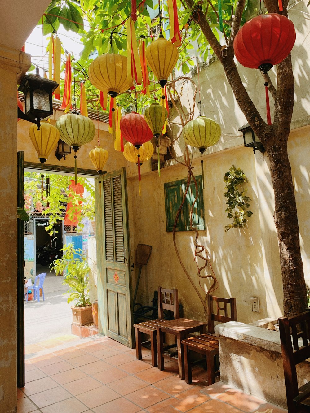 a courtyard with lanterns hanging from the ceiling