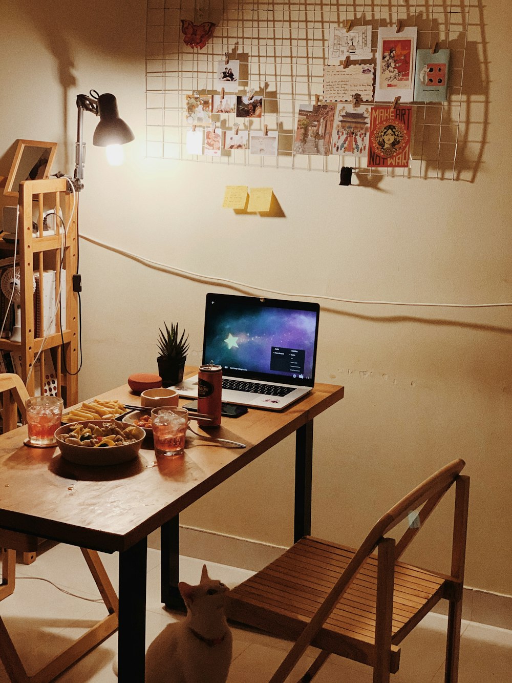 a laptop computer sitting on top of a wooden table