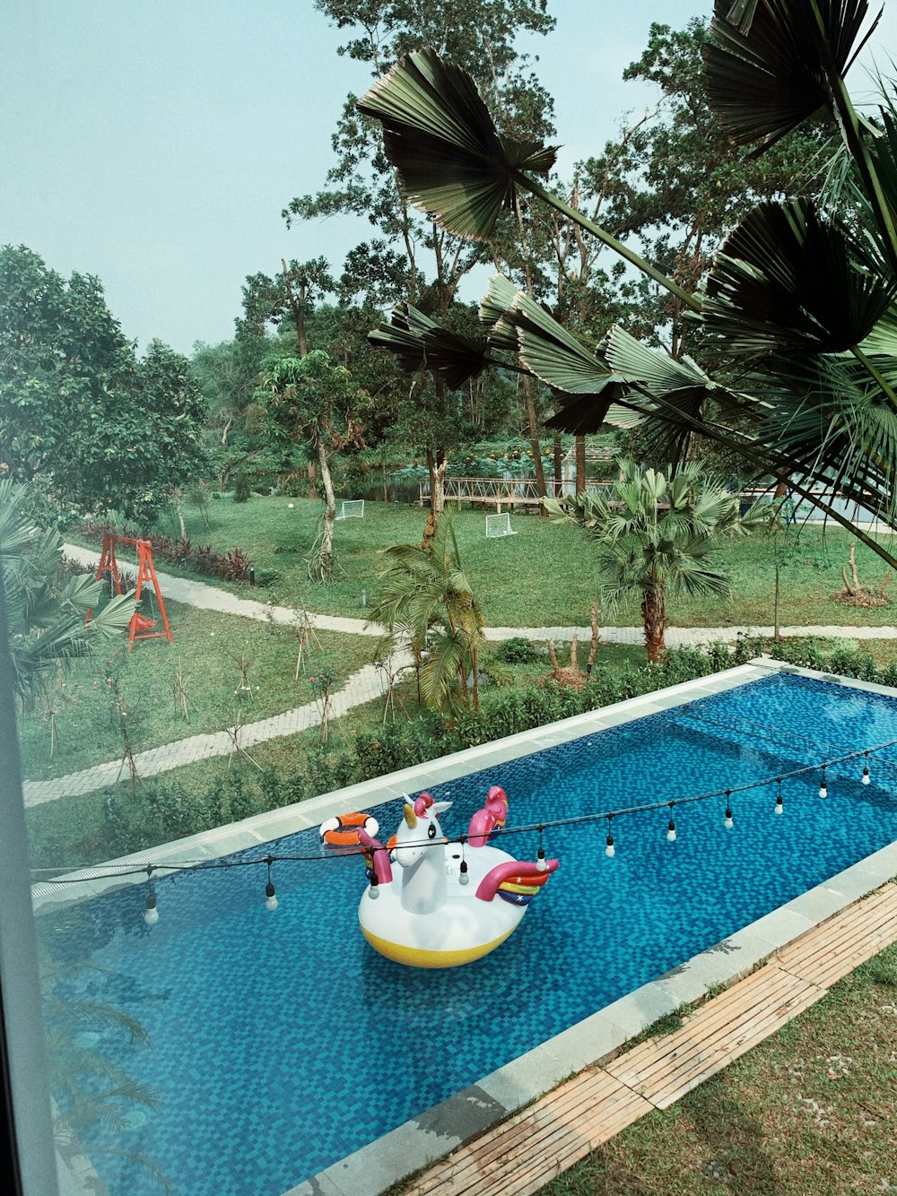 a pool with an inflatable float in the middle of it