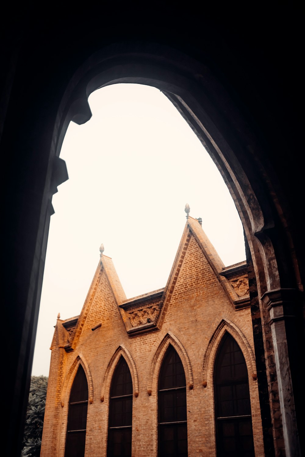 a view of a church through an arched window