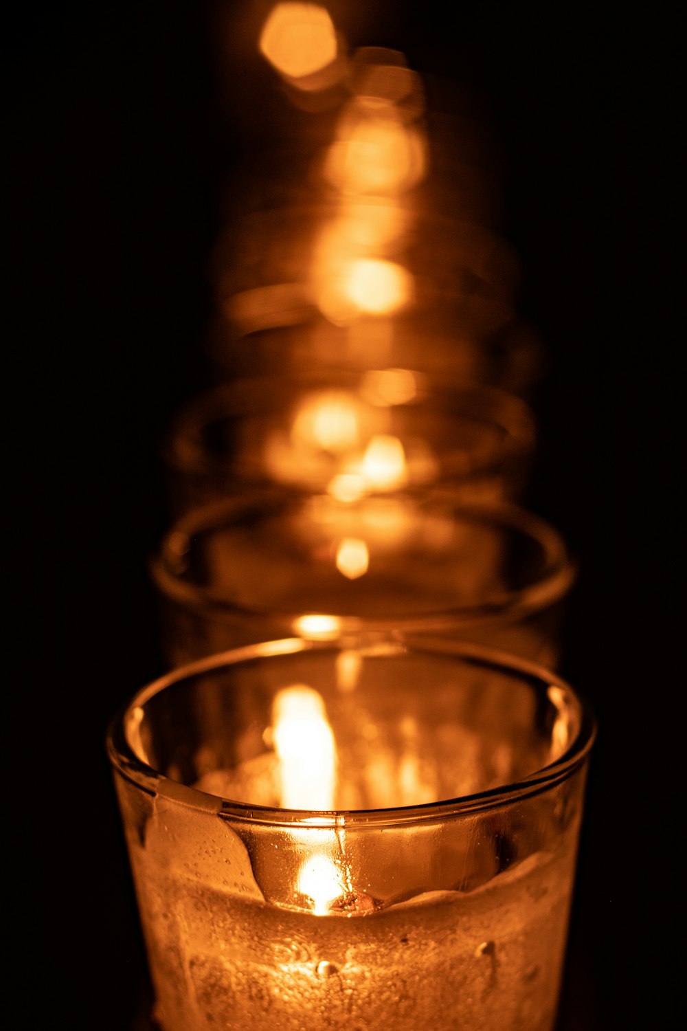 a row of lit candles sitting on top of a table