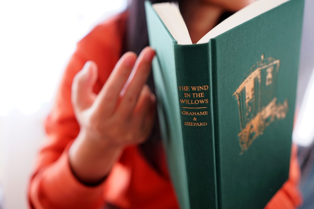 a person holding a book in their hands