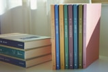a stack of books sitting on top of a table