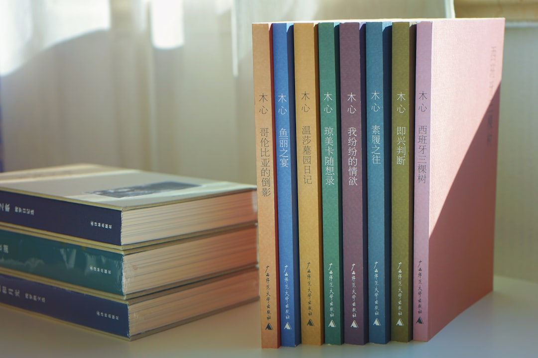 a stack of books sitting on top of a table,