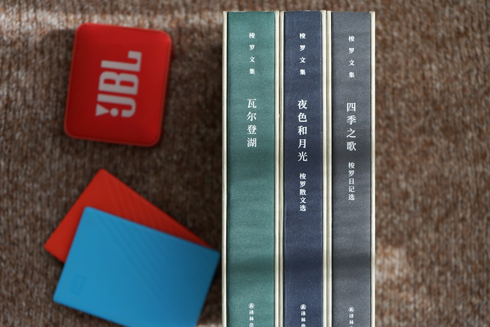 a close up of a keyboard and a book on a carpet