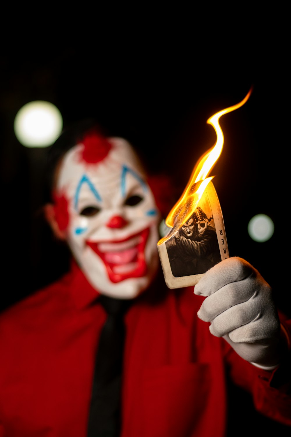 a man in a clown mask holding a cell phone