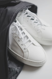 A pair of classic, minimalist leather shoes placed on a clean white surface.
