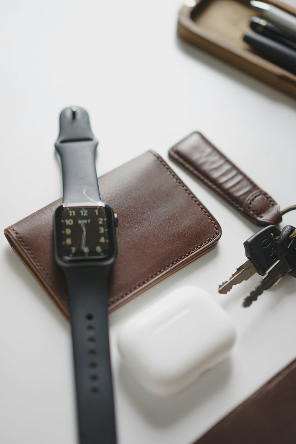 an apple watch sitting on top of a leather case