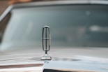 a close up of the hood ornament of a classic car