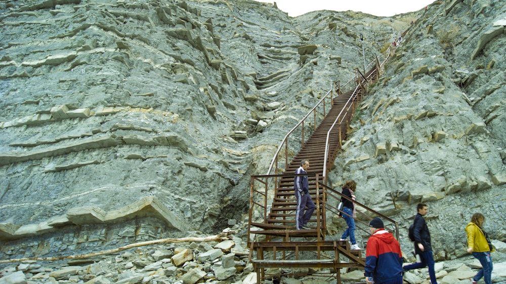 a group of people climbing up a mountain