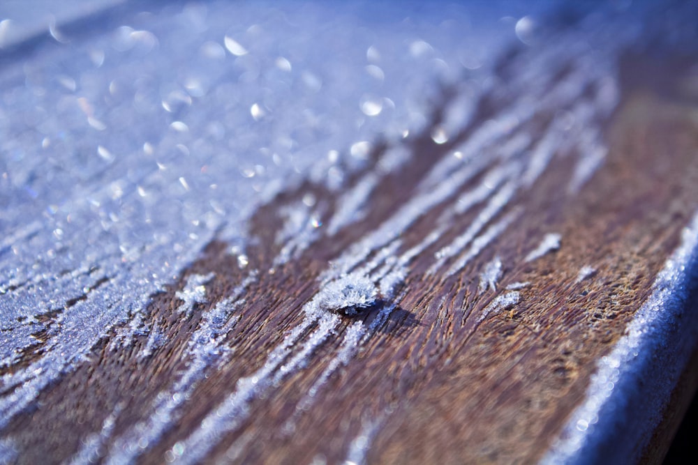 a close up of a wooden surface with drops of water on it