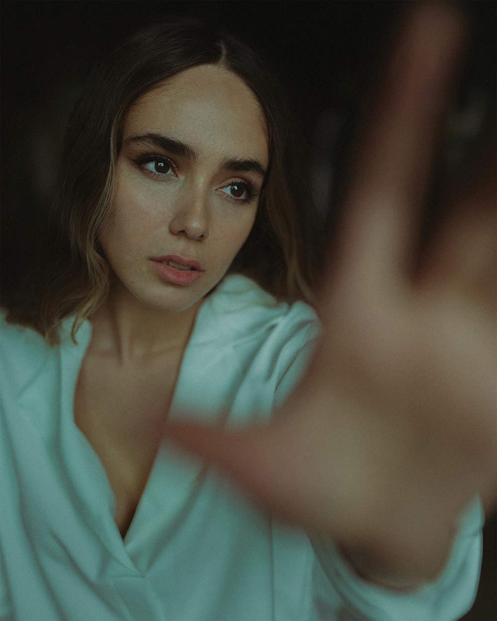 a woman is making a gesture with her hand