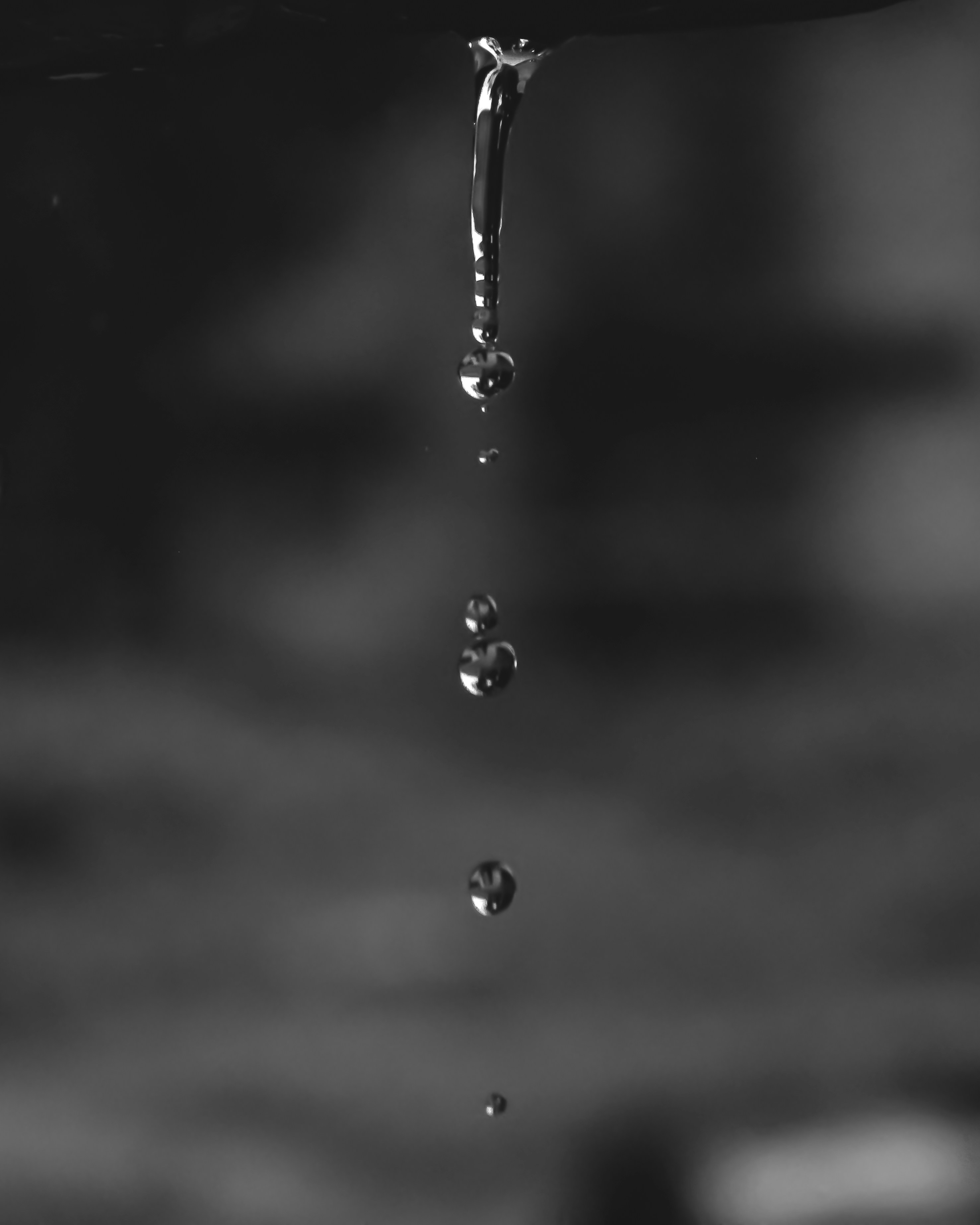 A black and white photo of water dripping from a faucet photo Free