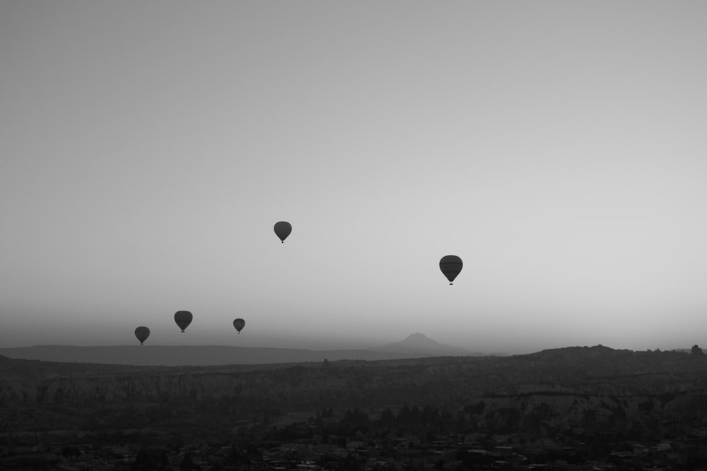 a group of hot air balloons flying in the sky