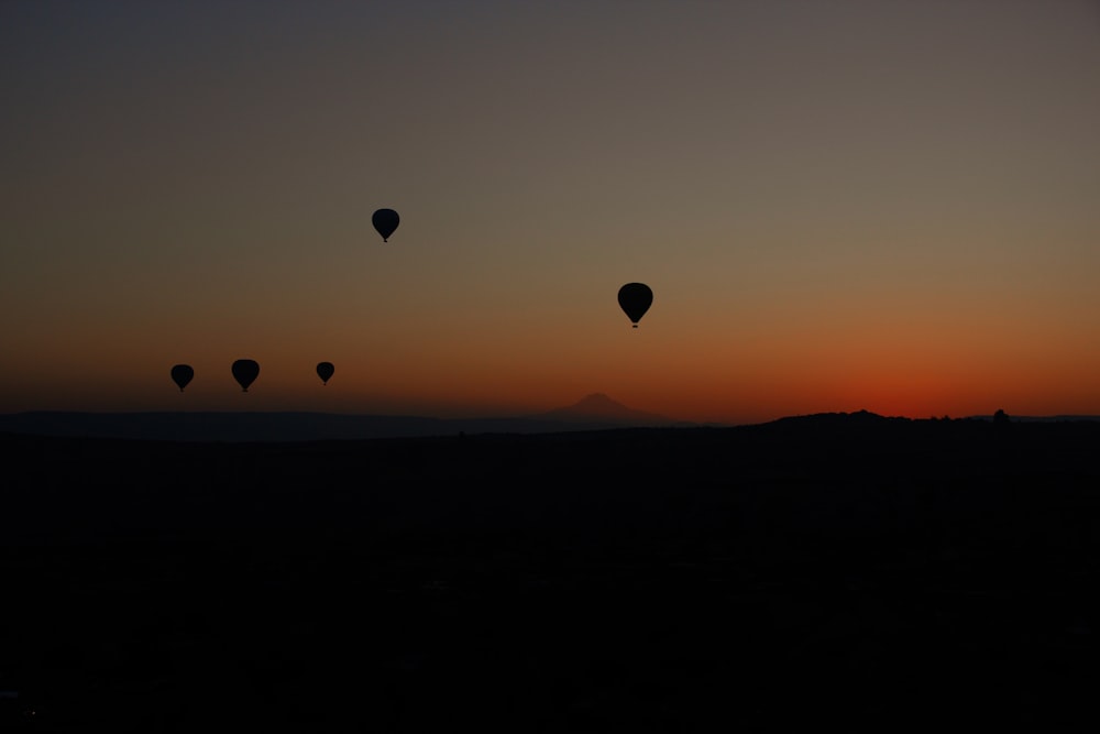 Eine Gruppe von Heißluftballons, die am Himmel fliegen