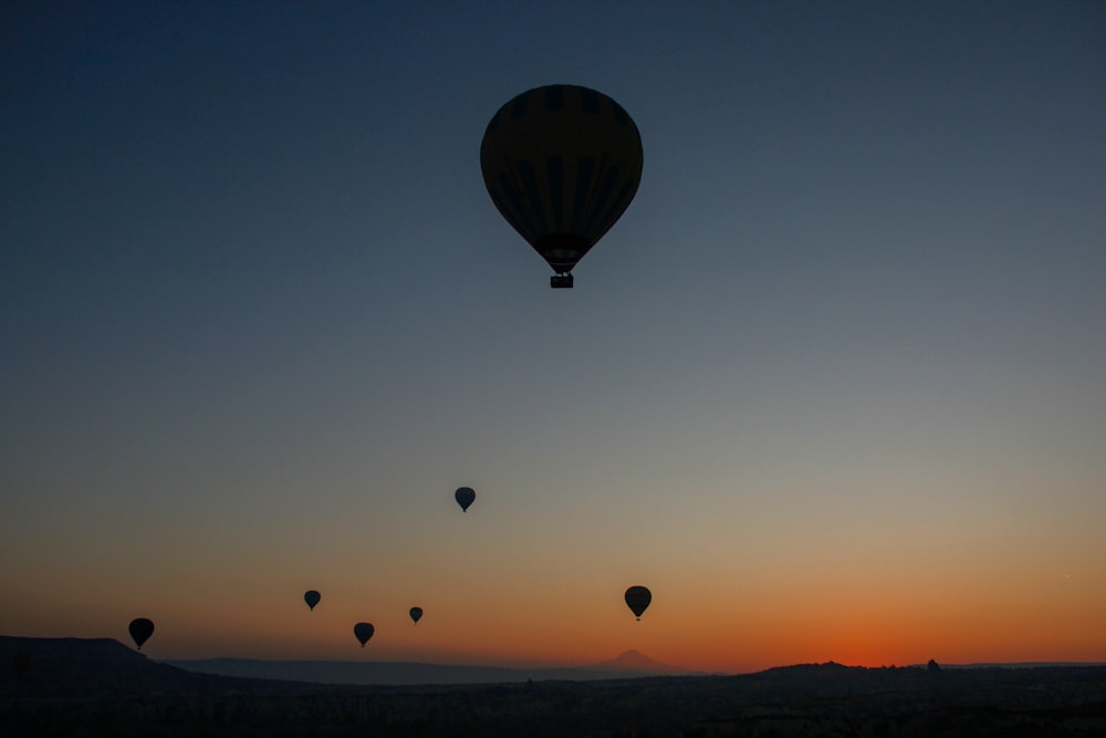 a group of hot air balloons flying in the sky