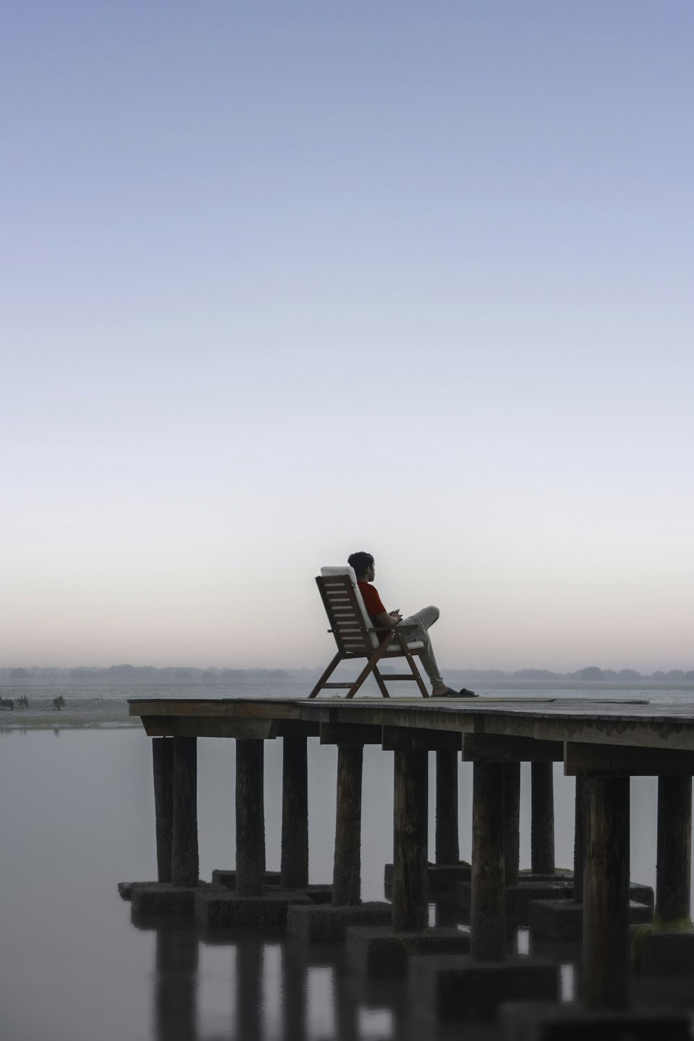 a chair sitting on top of a wooden pier