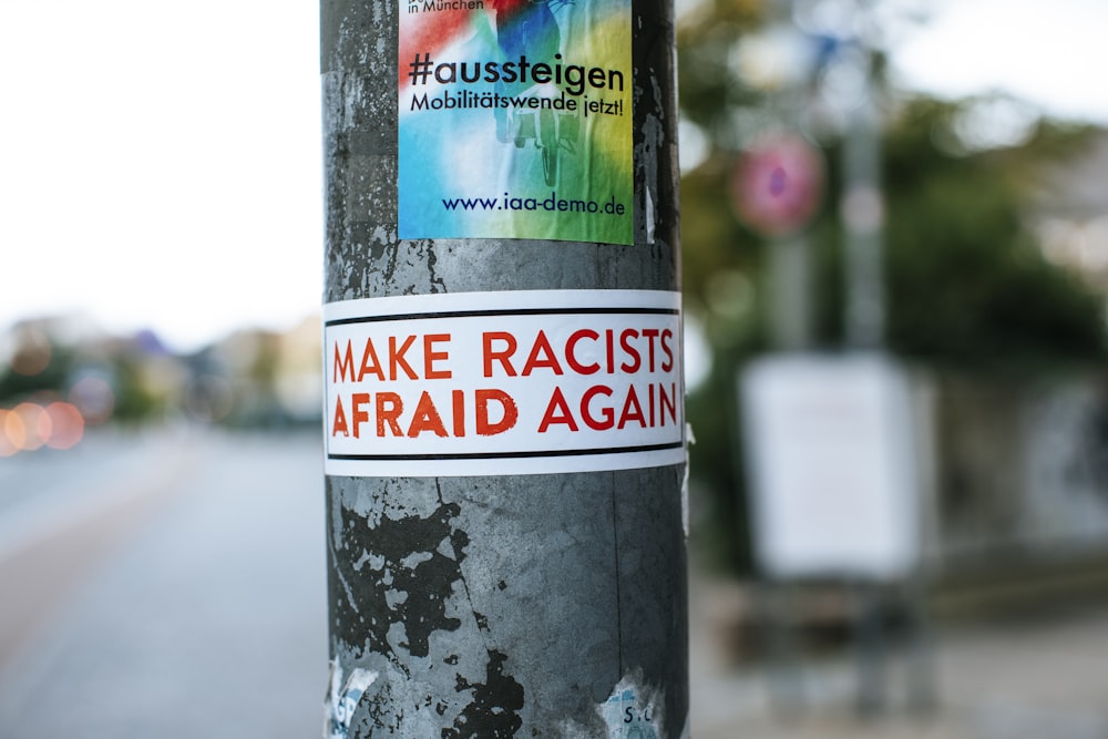 a sticker on a pole on a city street