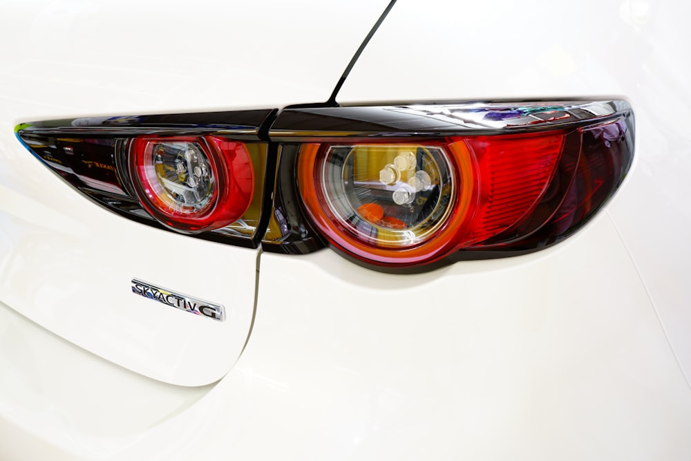 a close up of the tail lights of a white car