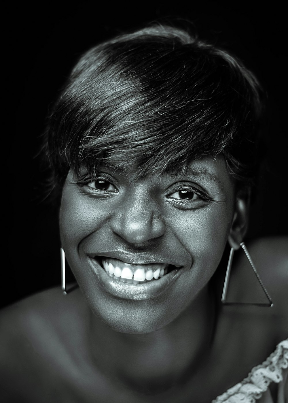 a black and white photo of a woman smiling