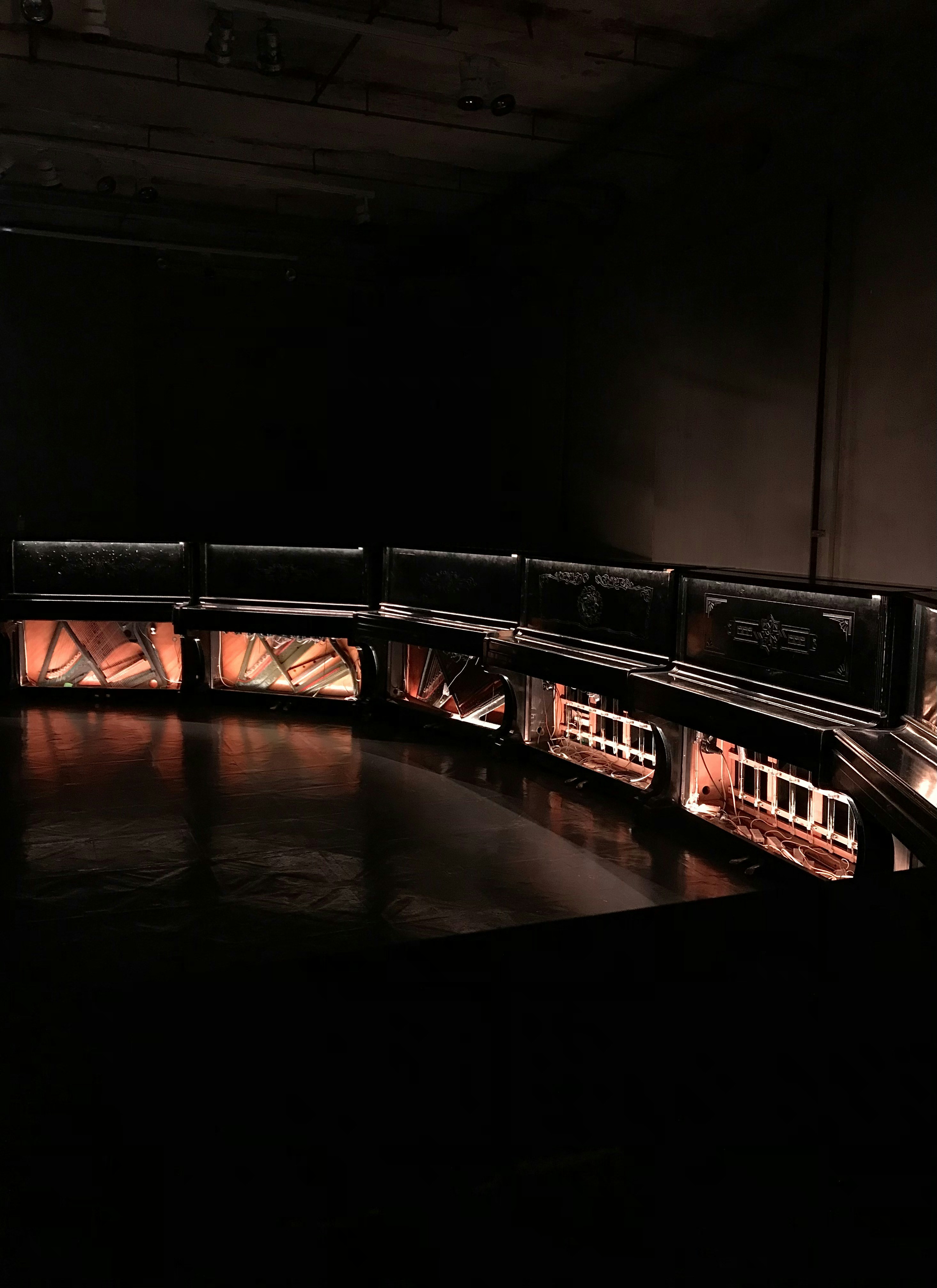 a dark room with a row of lights on the wall