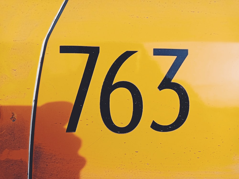 a close up of the numbers on a yellow vehicle