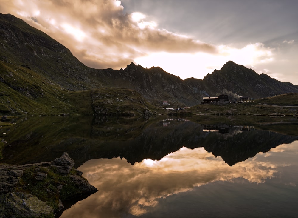 a mountain range with a lake in the foreground