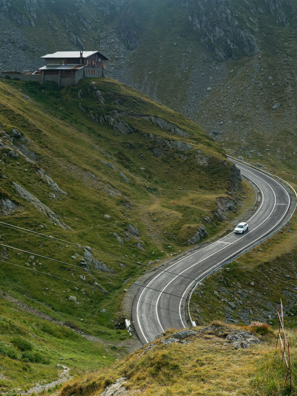 a car driving down a winding road in the mountains