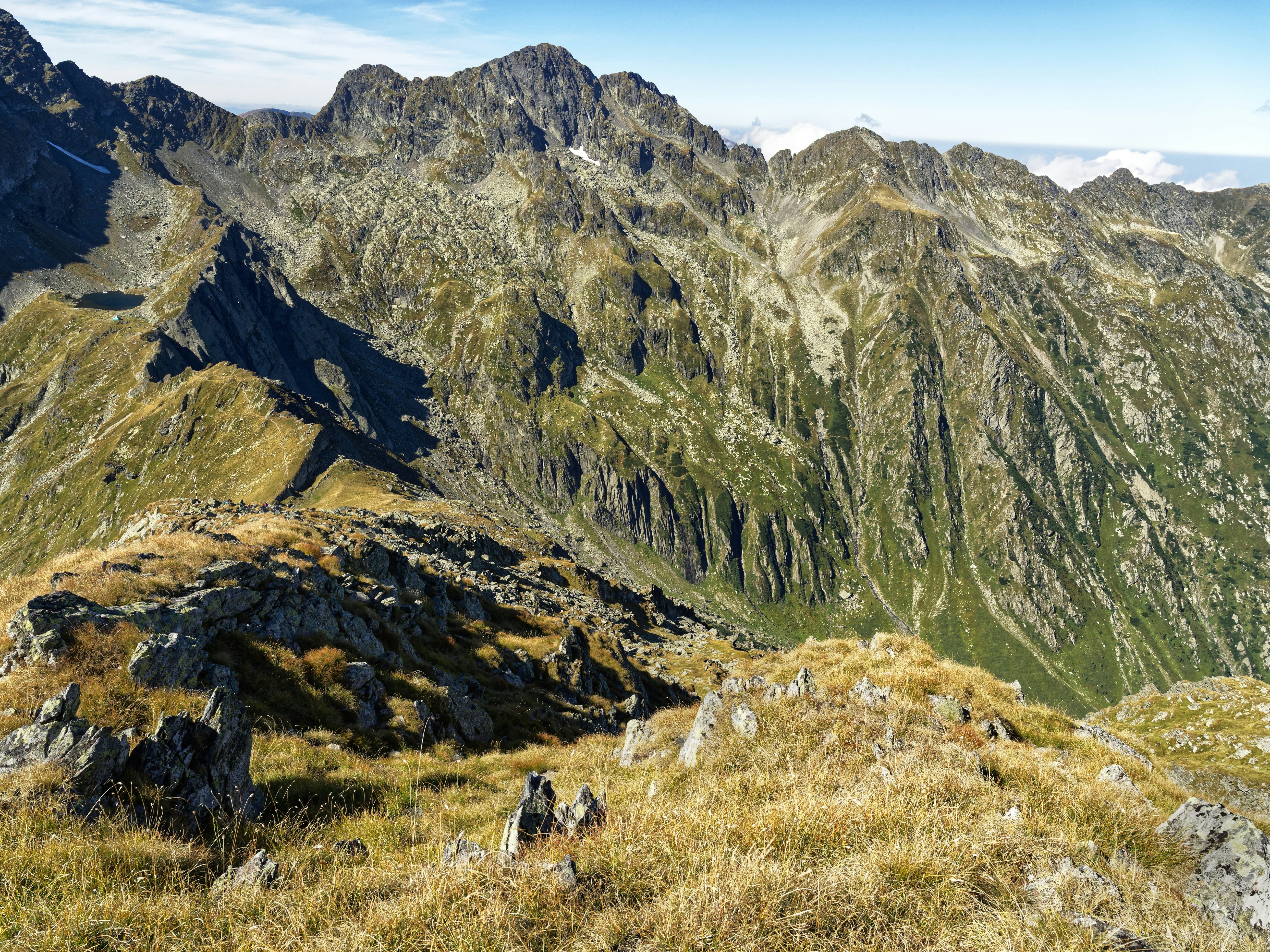a view of a mountain range from the top of a hill
