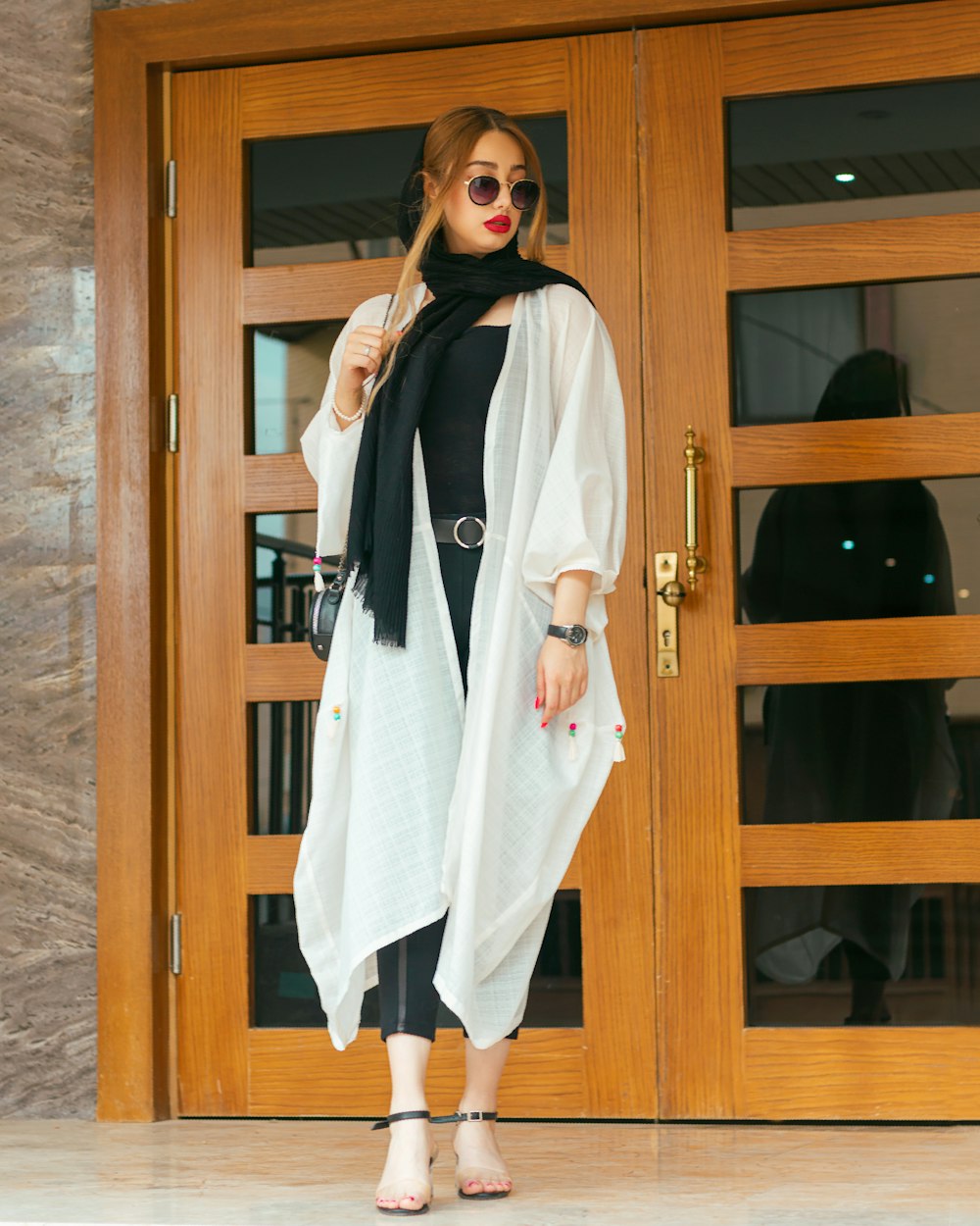 a woman standing in front of a wooden door