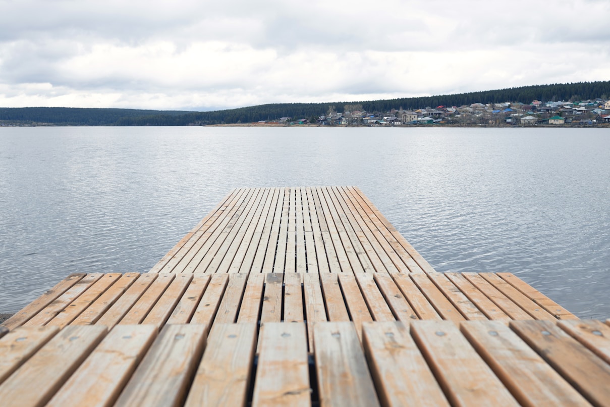 a wooden dock sitting on top of a lake