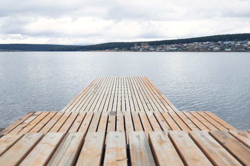 a wooden dock sitting on top of a lake