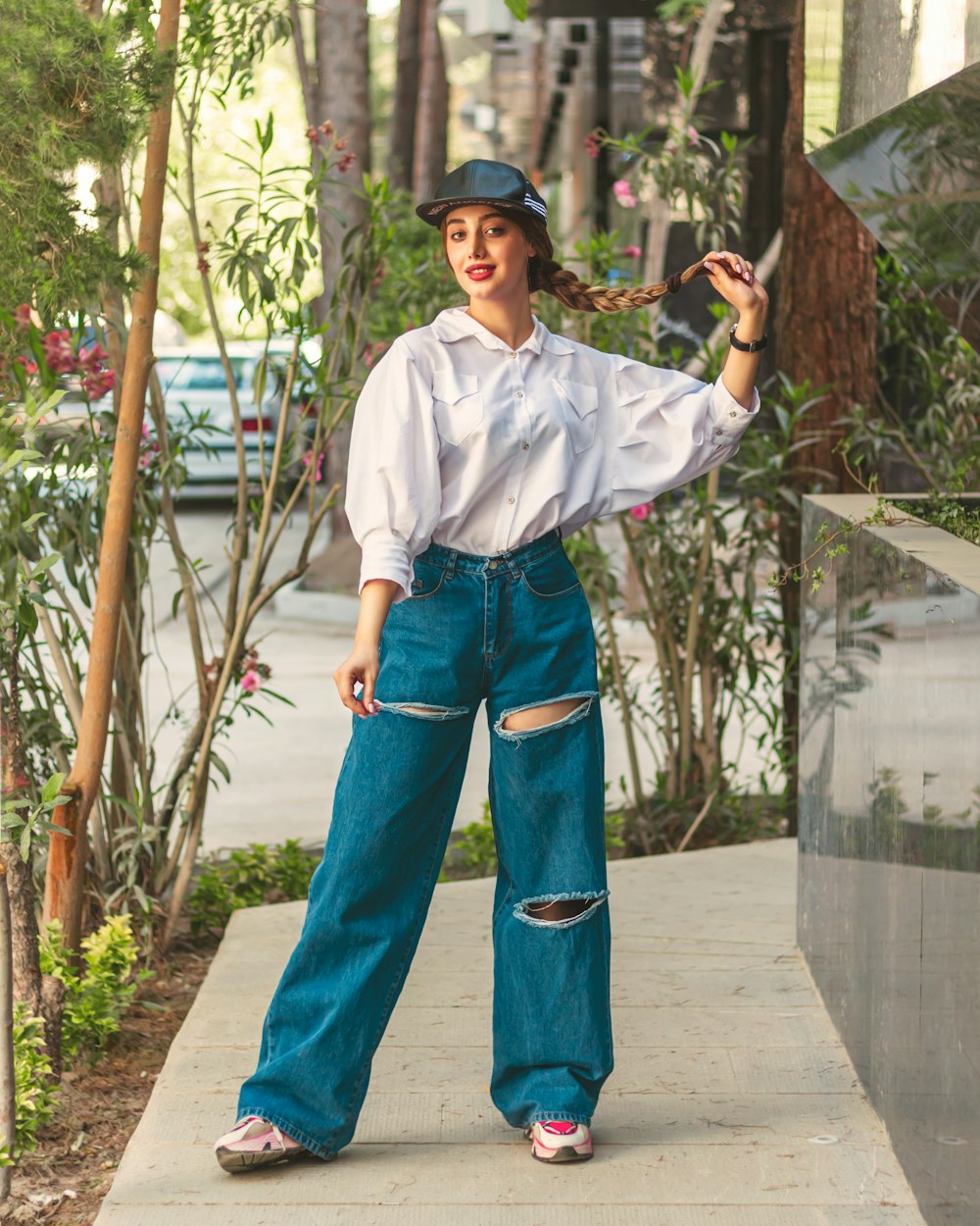 a woman in a white shirt and blue jeans