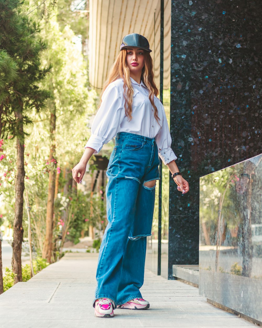 a woman in a white shirt and blue jeans