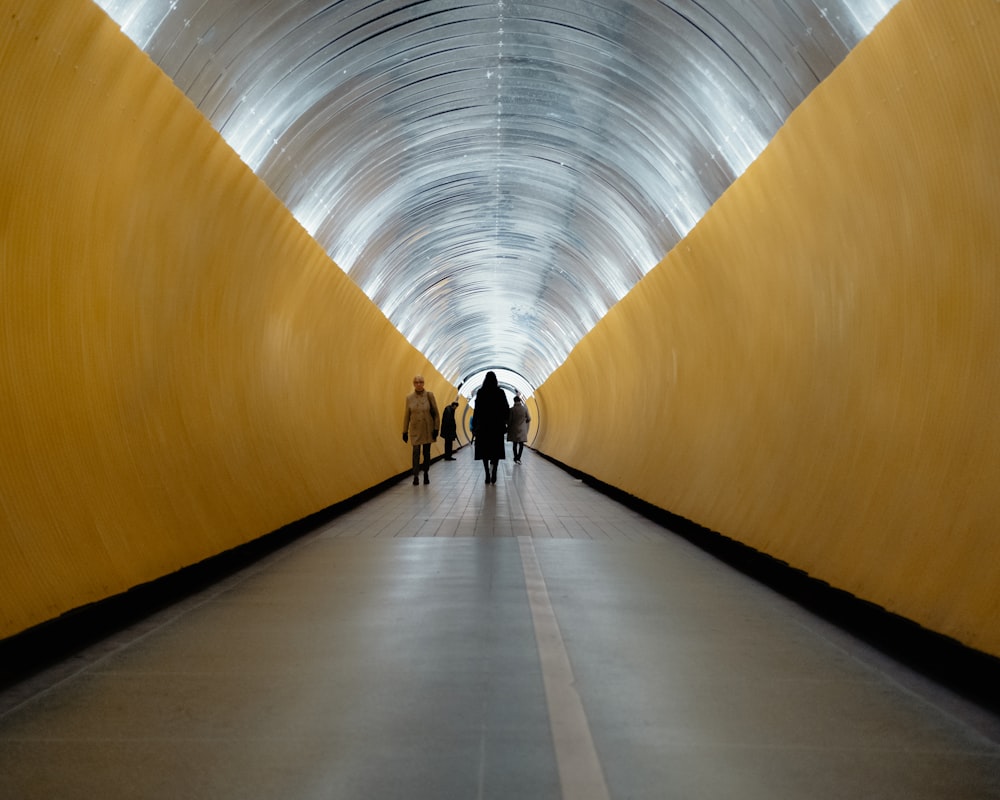 a group of people walking through a tunnel