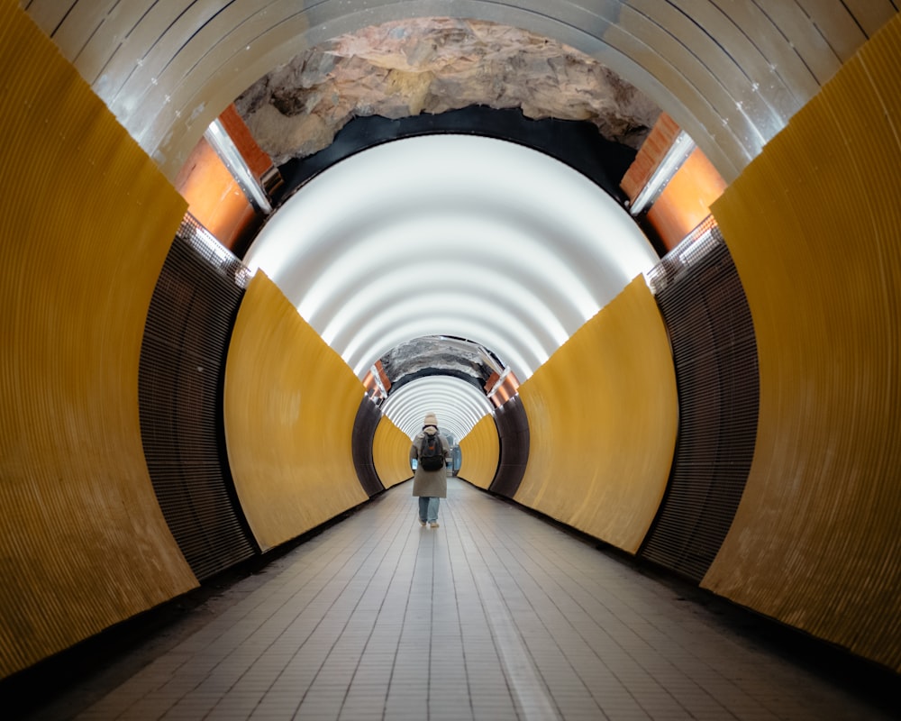 a person is walking down a long tunnel